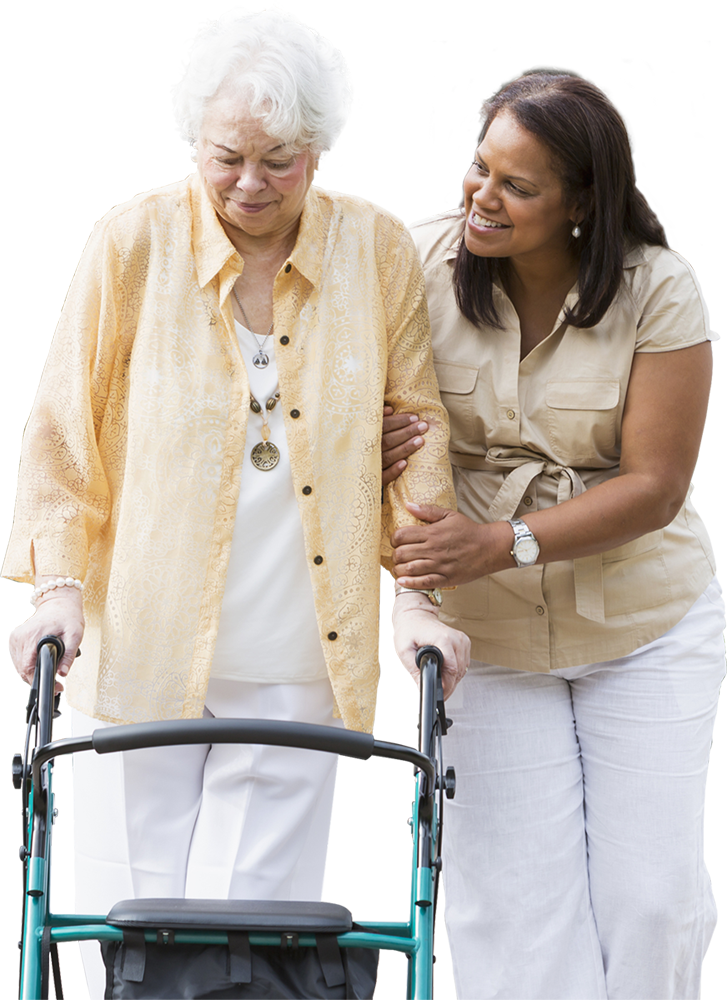 Caregiver helping an elderly woman walk with a walker.